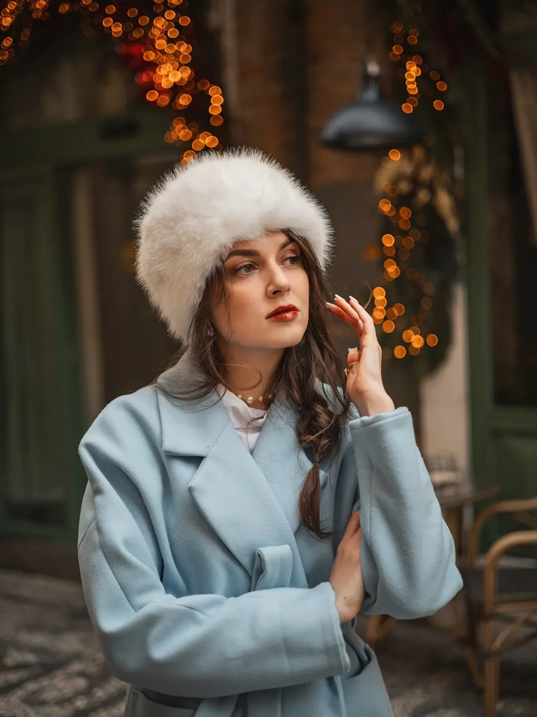 Child in vintage pajamas looking out window