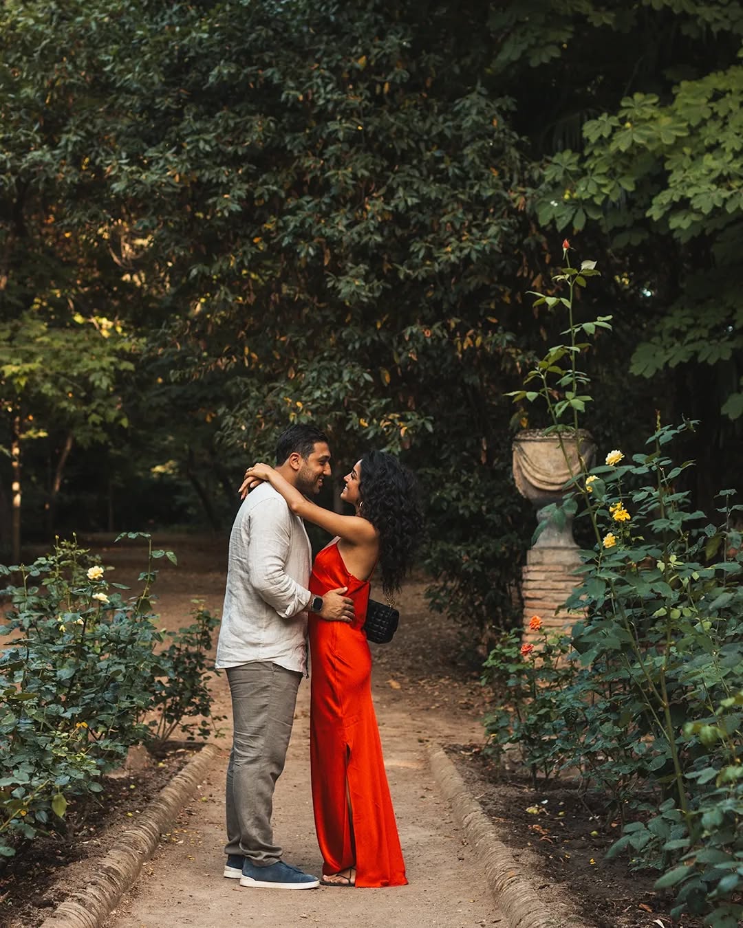 Couple walking through narrow Albaicín streets at golden hour